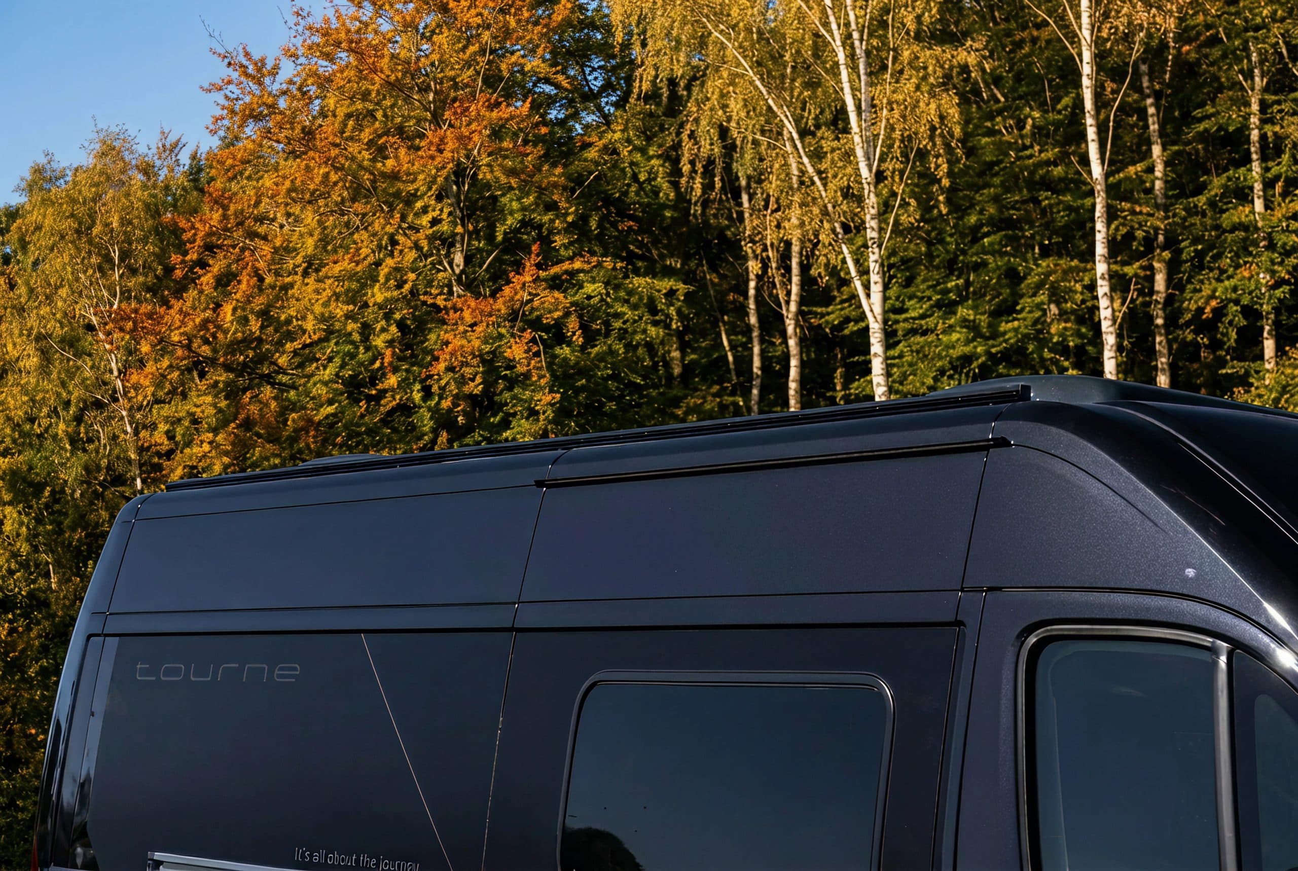 NordicStealth aluminium rail flush on van roofline, autumn birch forest