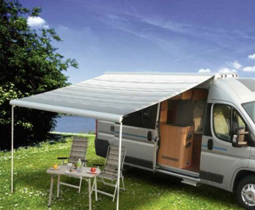 A fixed cassette awning out from the side of a white van.